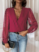 Chic Bodysuit with Statement Sleeves and V-Neck Design