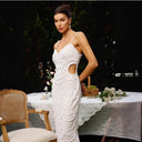 Chic Midi Dress with Unique Cut-Out Design and Artistic Pattern